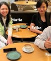 Four young people sitting around a table